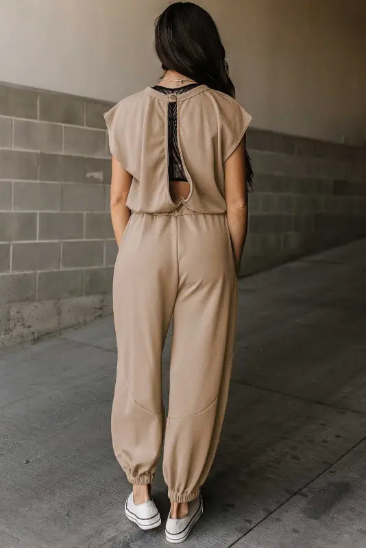 Open back drawstring jogger jumpsuit in beige with keyhole back and elastic ankle cuffs