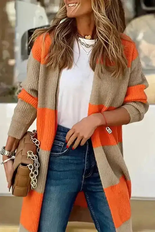 Casual fall outfit featuring orange colorblock cardigan with ribbed knit, styled with jeans and a white tee for everyday fashion.