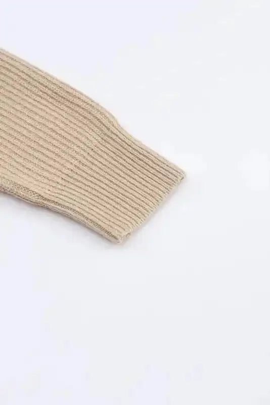 Detailed sleeve view of beige ribbed knit from the colorblock cardigan, showcasing the fine texture and stretchable fabric.