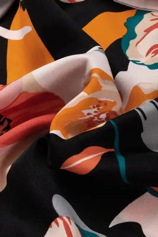 Close-up of soft fabric on Orange Floral Tie Neck Dress with long sleeves, showcasing vibrant floral print and smooth texture.