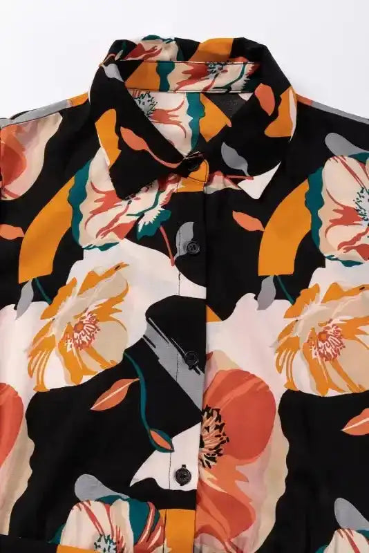 Close-up of collar and buttons on Orange Floral Tie Neck Dress, showing detailed floral print and soft fabric texture.