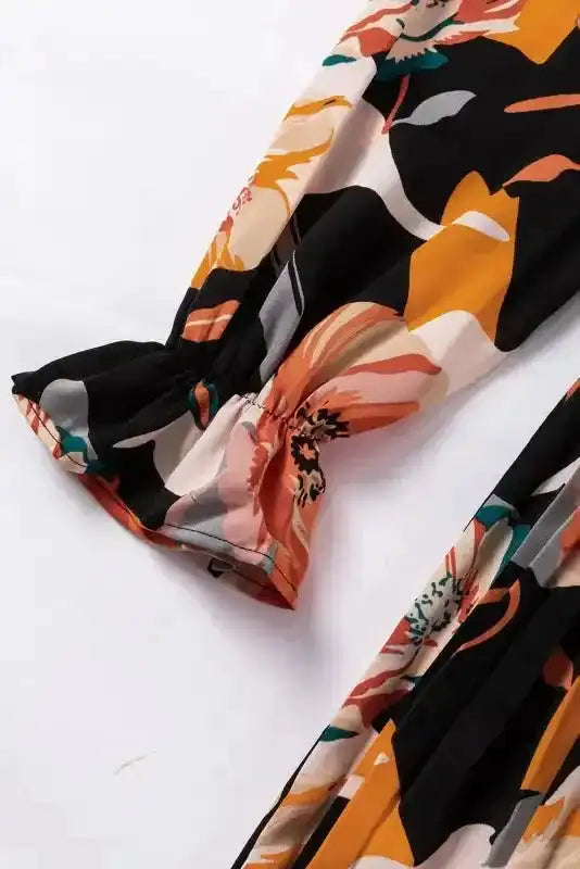 Sleeve cuff detail of Orange Floral Long Sleeve Dress with elastic finish and vivid floral pattern for a Southern Belle style.