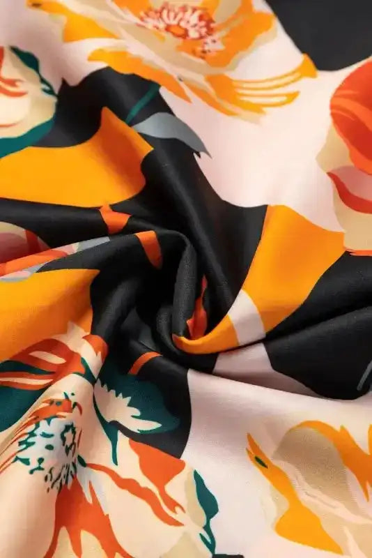 Soft, lightweight fabric of Orange Floral Long Sleeve Dress with vivid floral print, highlighting comfort and flowy texture.