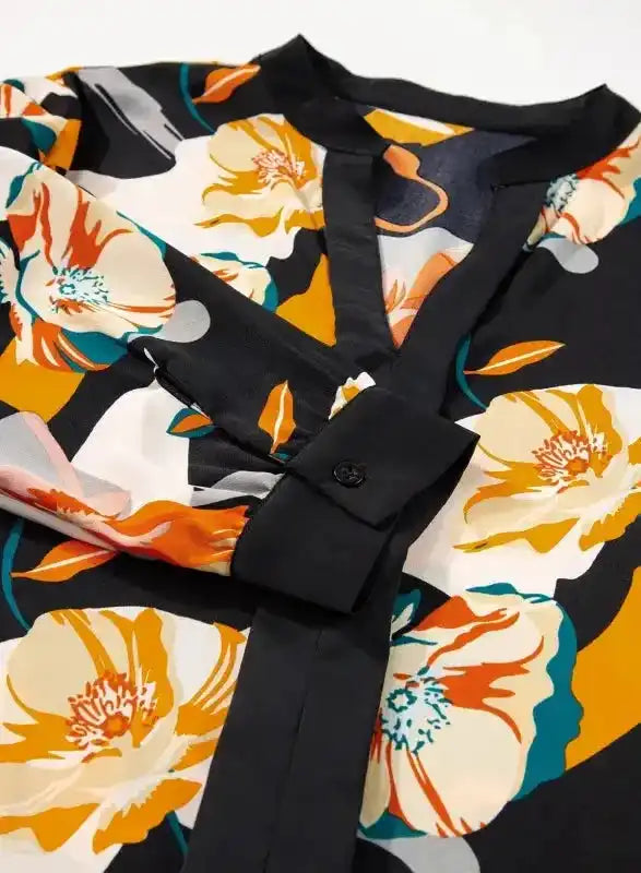 Cuff and button detail on sleeve of Orange Floral Long Sleeve Dress, showcasing elegant tailoring and floral design.