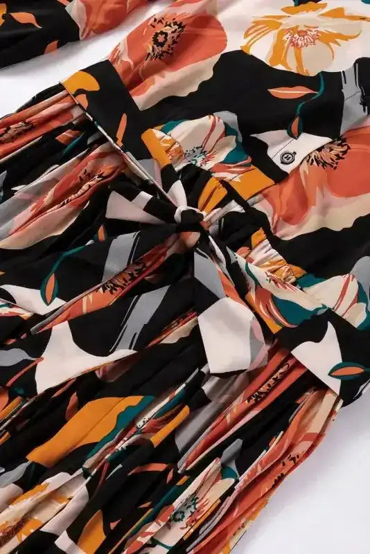 Back waist view of Orange Floral Tie Neck Dress featuring a bow tie and pleated skirt, ideal for daily or holiday wear.