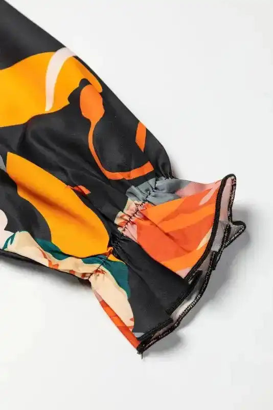 Close-up of elastic cuff on Orange Floral Tie Neck Dress, showcasing soft fabric and vibrant floral print for daily wear.