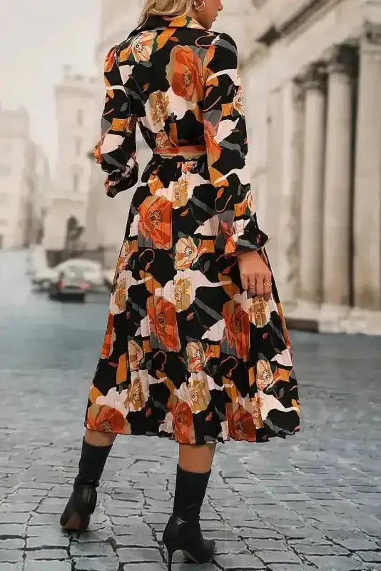 Back view of Orange Floral Long Sleeve Dress showing pleated A-line silhouette and high waist fit, perfect for stylish outings.