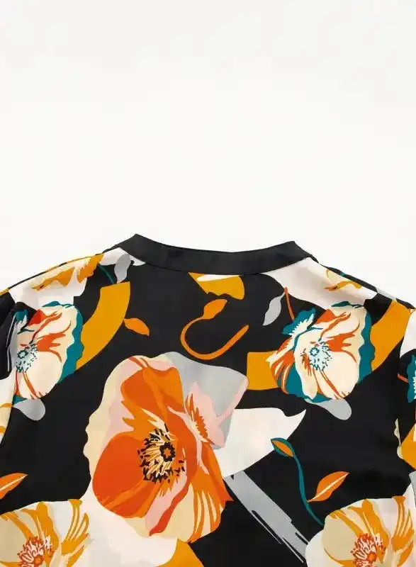 Back neckline close-up of Orange Floral Tie Neck Dress with bold floral print and smooth finish for a chic look.