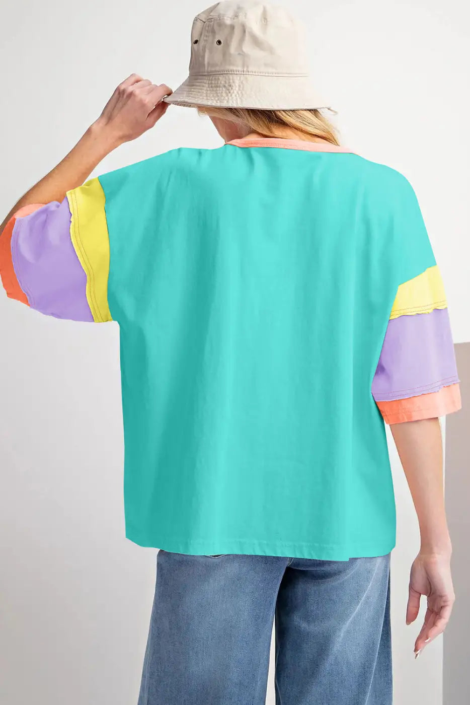 Oversized stitched top: colorful t-shirt with turquoise body and pastel sleeve accents