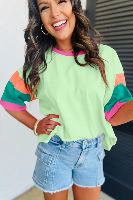 Oversized stitched top: colorful short-sleeved with mint body & striped sleeves, denim shorts