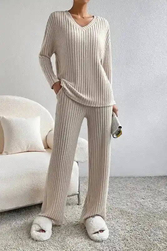 Plus size beige ribbed V-neck pullover and pants set with high elasticity, styled for comfort and casual elegance at home.