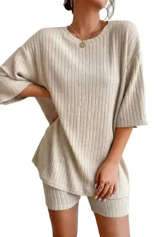 Beige ribbed plus size pullover and shorts set with relaxed fit and short sleeves, styled for casual comfort.