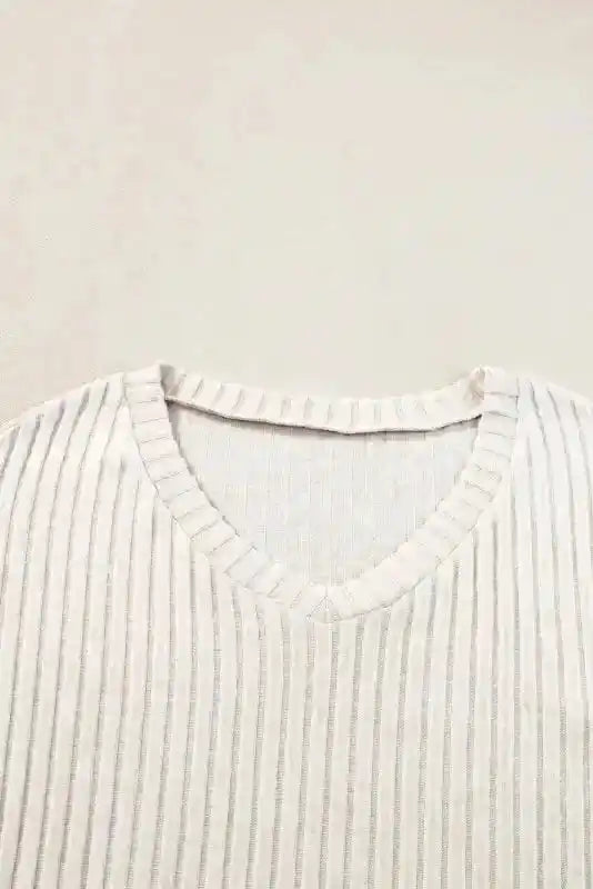 Close-up of V-neckline on Plus Size Ribbed Pullover showing detailed ribbed knit fabric and soft stretch material.