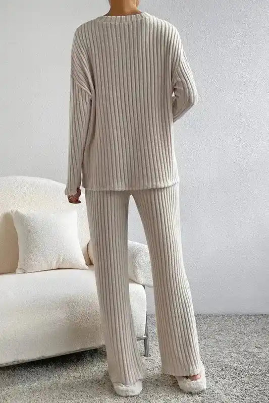 Back view of beige plus size ribbed V-neck pullover pants set featuring wide-leg pants and relaxed fit for comfort.