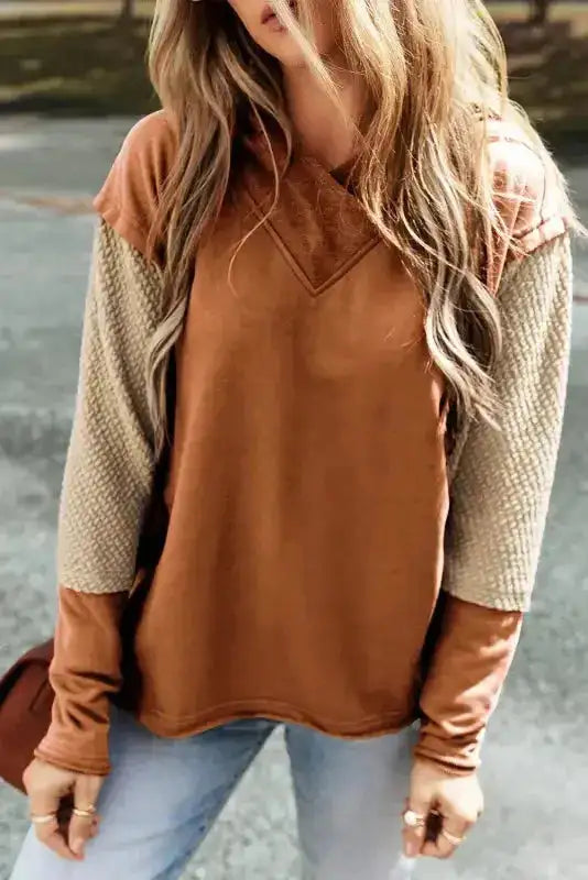 Solid brown version of the Patchwork Leopard Hoodie with waffle-knit sleeves and oversized fit, styled with light denim jeans.
