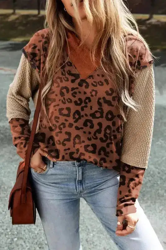 Front view of Patchwork Leopard Hoodie Oversized Textured Knit featuring leopard print, waffle-knit sleeves, and relaxed fit for streetwear fashion.