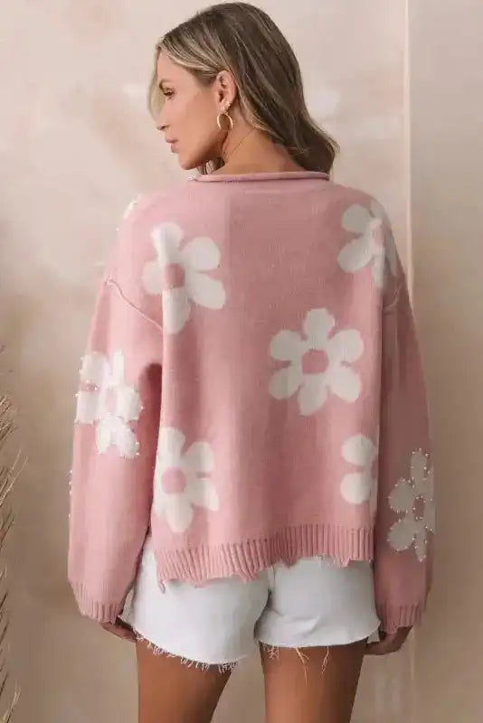 Back view of the Ladies Pink Pearl Beaded Floral Sweater by FashionFitz showing white floral beaded details on sleeves and back.