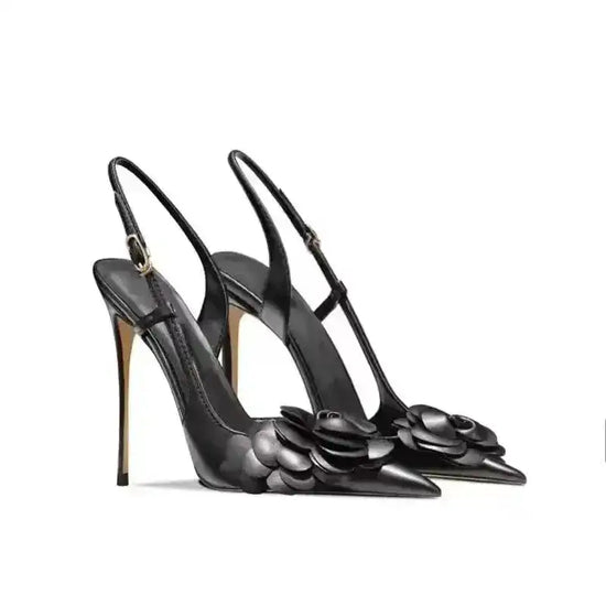 Black Petal Pirouette Slingback Heels in a pair, featuring floral embellishments and sleek silhouette for elegant fashion statements.