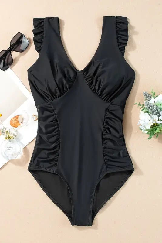 One-piece bathing suit with ruched details and ruffled straps for a relax relax beach day