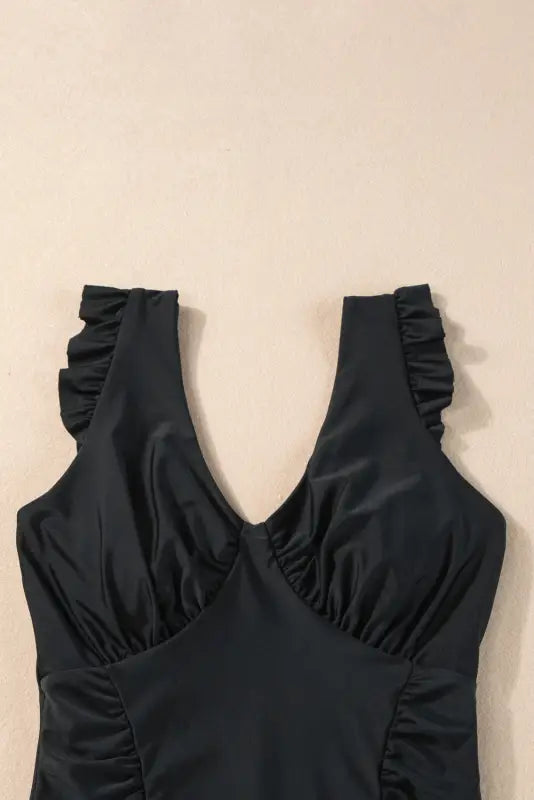 One piece bathing suit - black ruffled trim ruched with v-neckline and shoulder straps