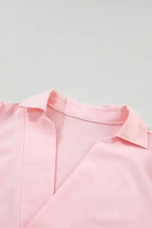 Collar and neckline close-up of the Ladies Pink Polo V-Neck Top, featuring a stylish open V-cut and soft cotton blend material.