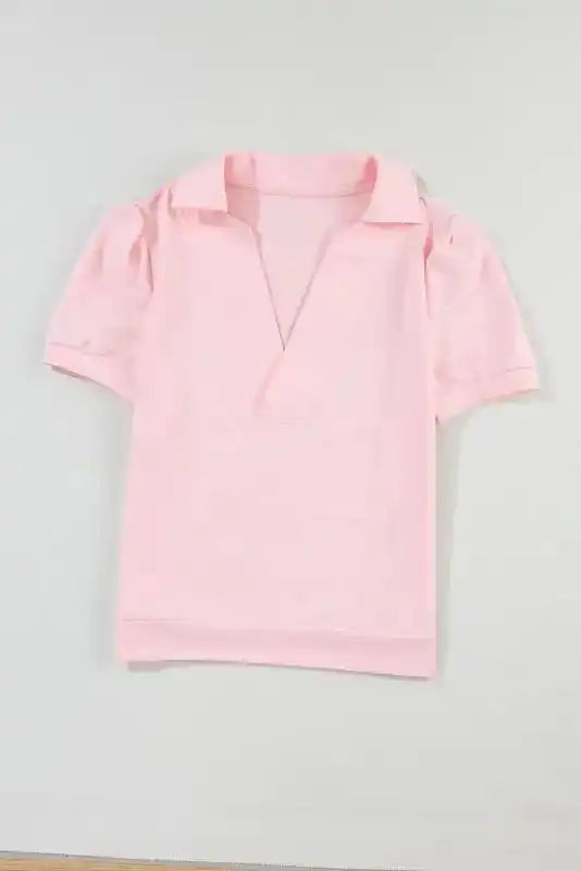 Flat lay of the Ladies Pink Polo V-Neck Top with puff sleeves, showcasing its soft cotton fabric and feminine Southern Belle style.