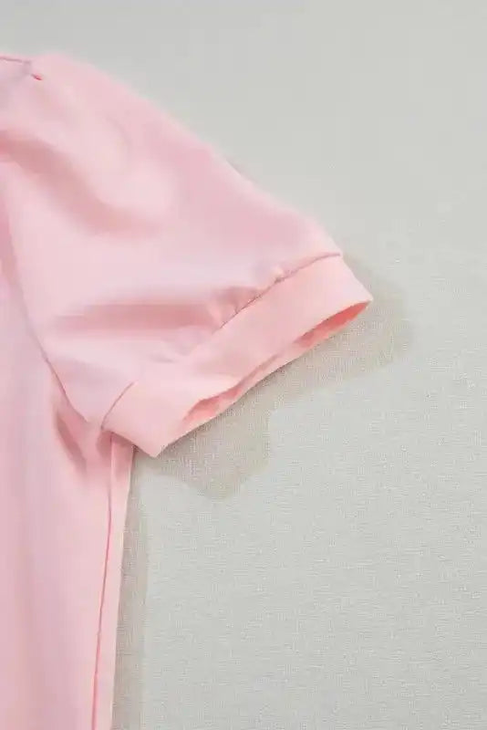 Detailed view of puff sleeve on the pink V-neck top, emphasizing the soft cotton fabric and feminine Southern Belle style.