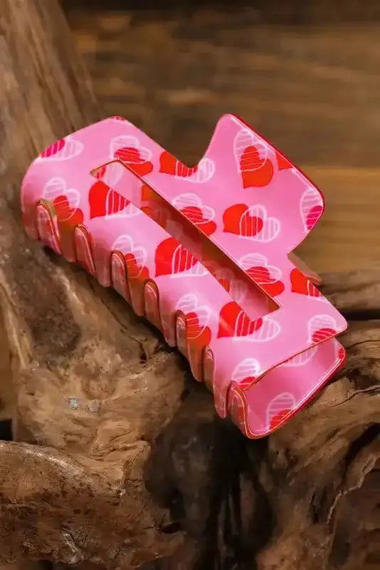 Side view of pink heart-patterned Valentines hair claw clip, ideal for adding charm to everyday or date night looks.