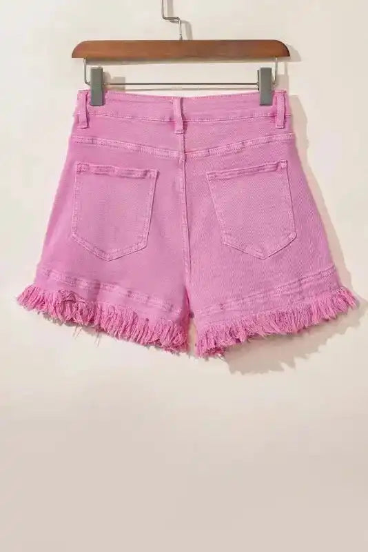 Back flat lay of ladies pink denim shorts with frayed hem, crafted from stretch cotton for a comfortable fit.