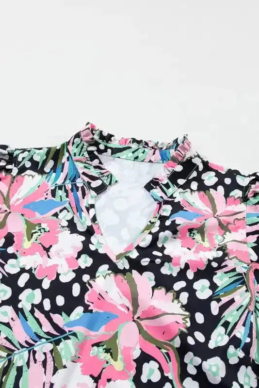 Close-up of neckline on pink leopard floral mini dress with ruffle trim and V-cut detail, emphasizing the feminine design.