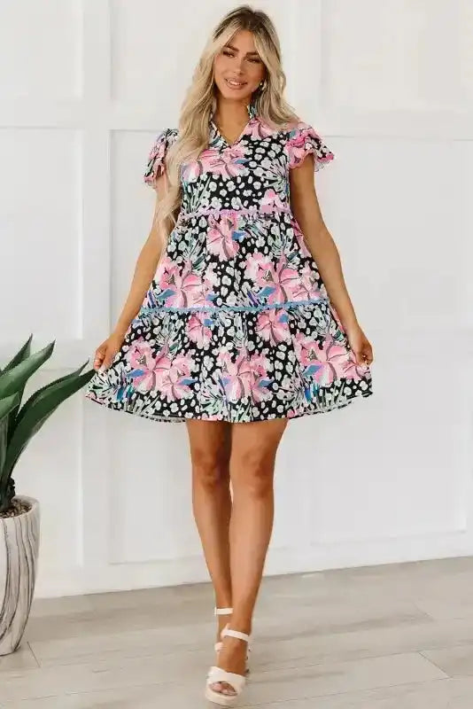 Model wearing pink leopard floral mini dress with tiered A-line silhouette and wavy hem, ideal for parties or daily summer outings.
