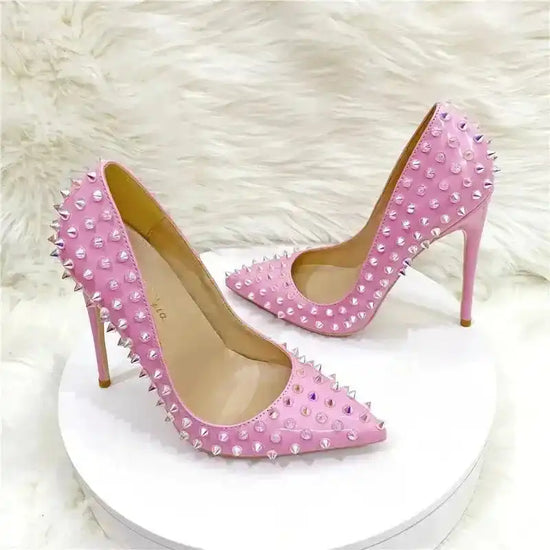 Bold pink studded stilettos from FashionFitz featuring pointed toes and high heels, ideal for statement looks and special occasions.