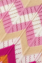Detailed view of pink chevron crochet jumper fabric showing openwork knit and color block pattern. Lightweight and textured for warm weather.