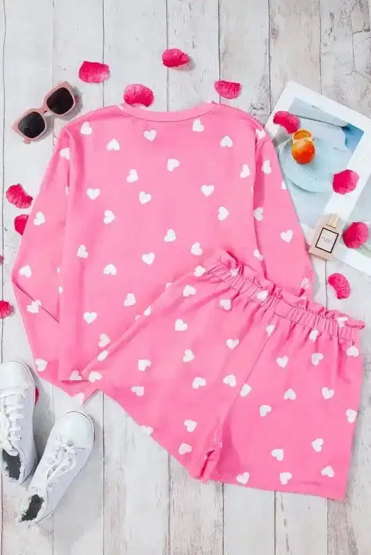 Flat lay of Pink Valentine Lounge Set with heart print tee and shorts, styled with accessories for a cozy loungewear look.