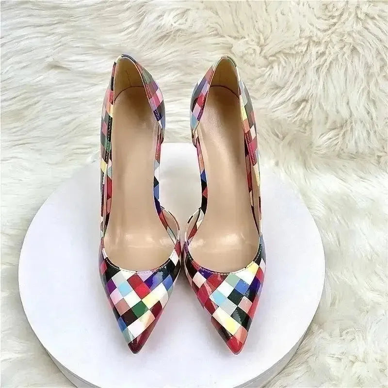 Top view of Pixel High Heels Stiletto Shoes on white platform, showcasing pointed toe and colorful pixel design for stylish women.