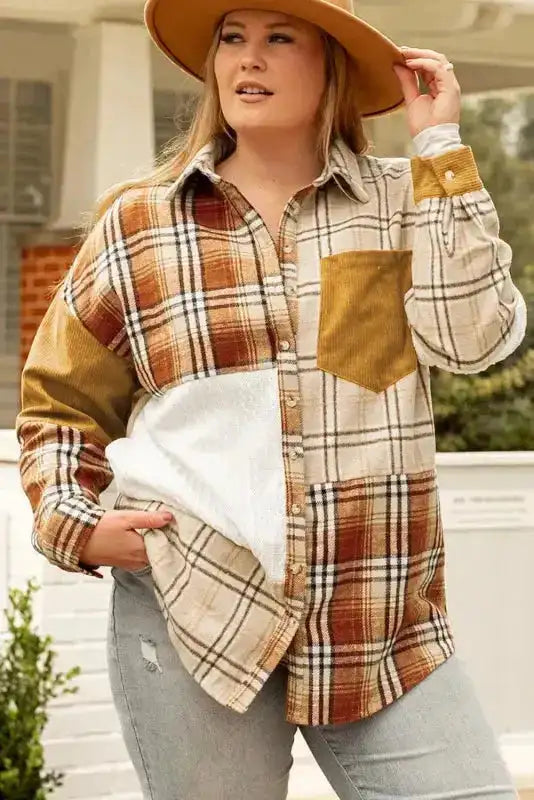 Plus-size model in the FashionFitz plaid patchwork shacket styled with jeans and a wide-brim hat for a western fall look.