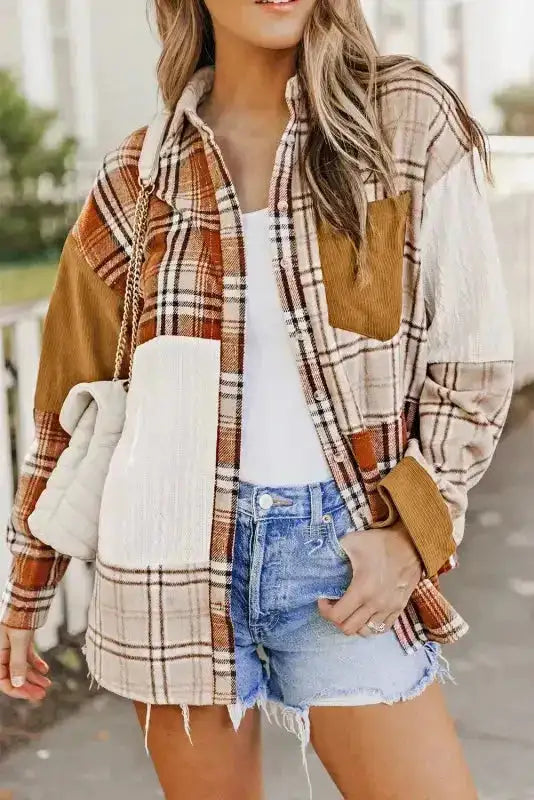Close-up of the FashionFitz plaid shacket highlighting the patchwork design and corduroy pocket detail.