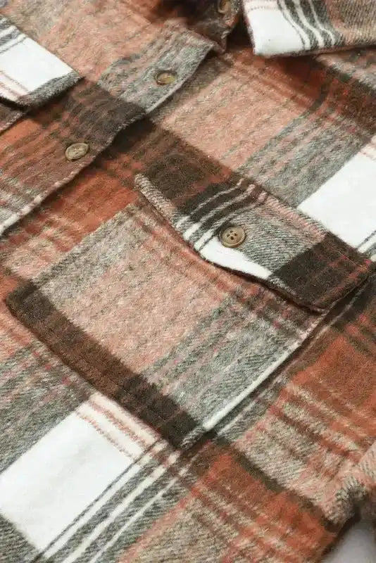 Detailed view of flap pocket and button stitching on plaid shacket, ideal for fall fashion lovers.
