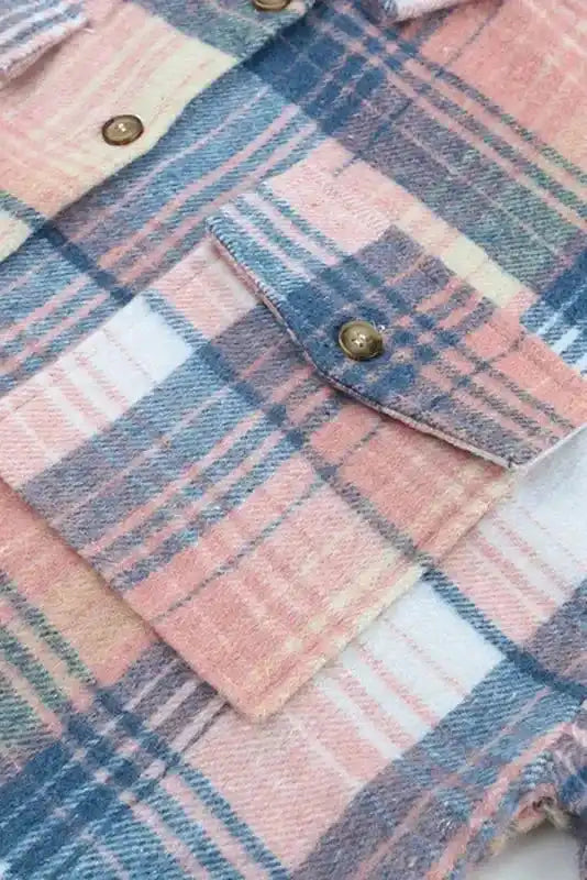 Detailed view of flap pocket and button on pastel plaid Stylish Plaid Shacket, emphasizing fabric and stitching.