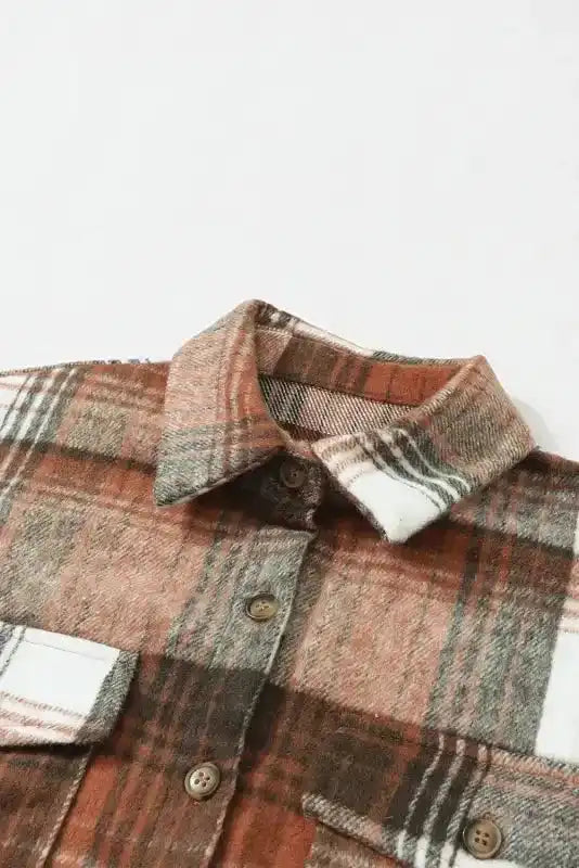 Close-up of collar and buttons on plaid shacket flap pockets, emphasizing cozy fall fabric texture.
