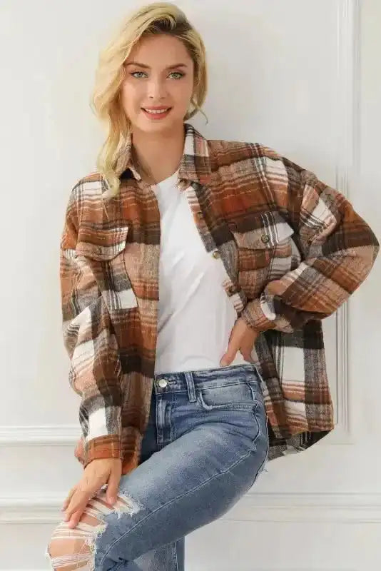 Plaid shacket flap pockets worn open over a white top, perfect for layering in autumn fashion.