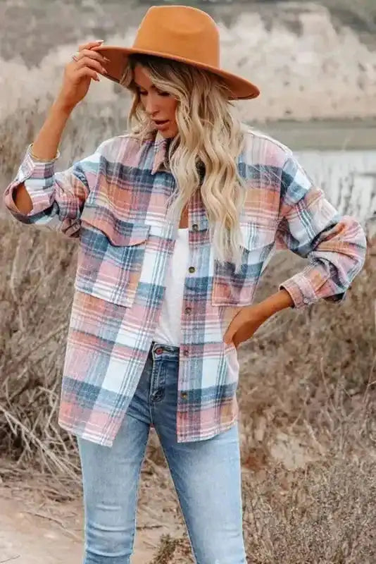 Front view of Stylish Plaid Shacket with Flap Pockets in pastel plaid, styled with jeans and a tan hat for autumn fashion.