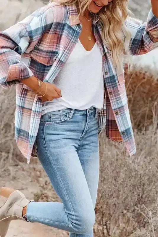 Model in motion wearing pastel plaid Stylish Plaid Shacket with Flap Pockets, paired with light jeans and a white tee.
