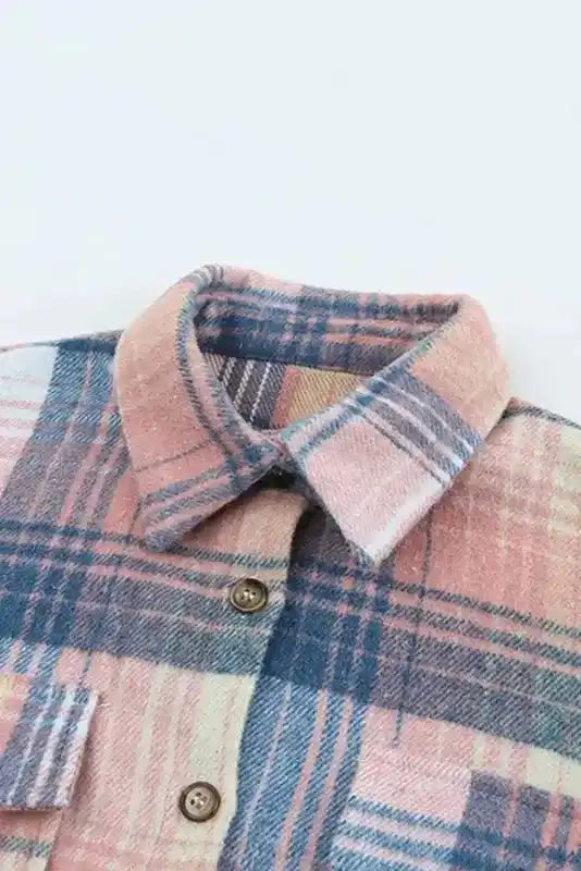 Close-up of collar and upper chest area of pastel plaid Stylish Plaid Shacket with Flap Pockets, showing button detail.