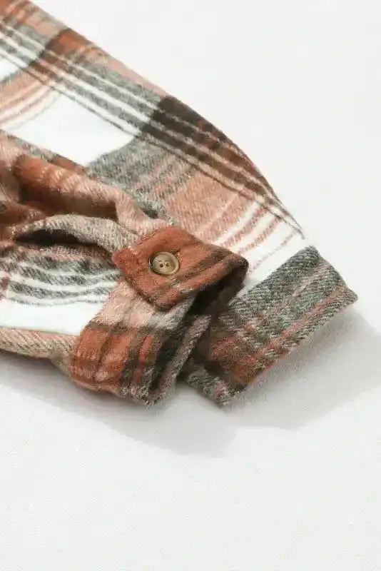 Cuff and sleeve button detail of plaid shacket flap pockets, showcasing quality fall outerwear finish.