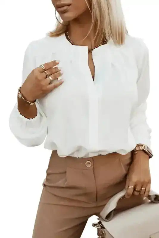 Model wearing white Pleated Neck Stretch Cuff Shirt tucked into beige pants, styled for work or weekend elegance in women's fashion.