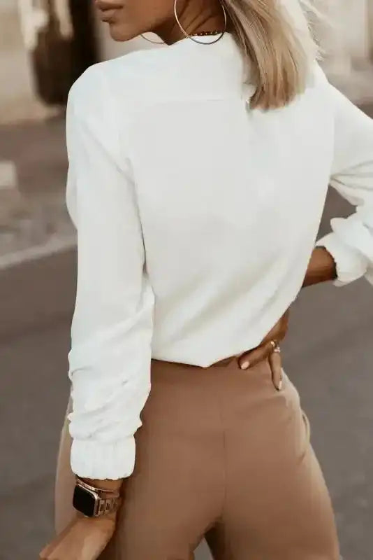 Back view of white Pleated Neck Stretch Cuff Shirt showing clean lines and soft fabric. A staple top for autumn outfits.