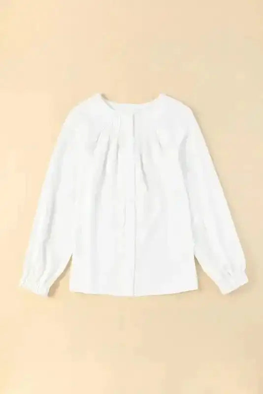 Front view of Pleated Neck Stretch Cuff Shirt laid flat on beige background, highlighting its elegant pleats and long sleeves.