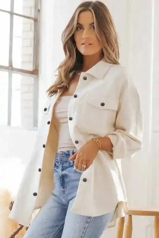 Textured plus size jacket in white worn open over a beige top and jeans, perfect for layering in cold weather.