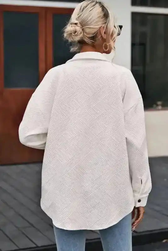 Back view of a white textured plus size jacket showing its relaxed fit and ribbed pattern, suitable for winter layering.
